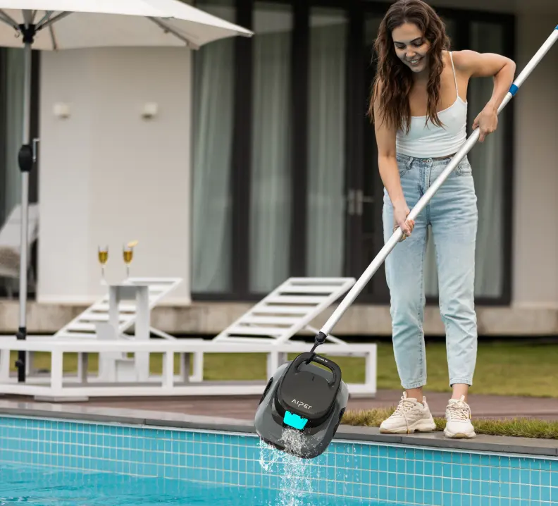 Pool owner retrieving an Aiper Scuba SE from an above-ground pool